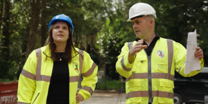 Two people wearing hi viz